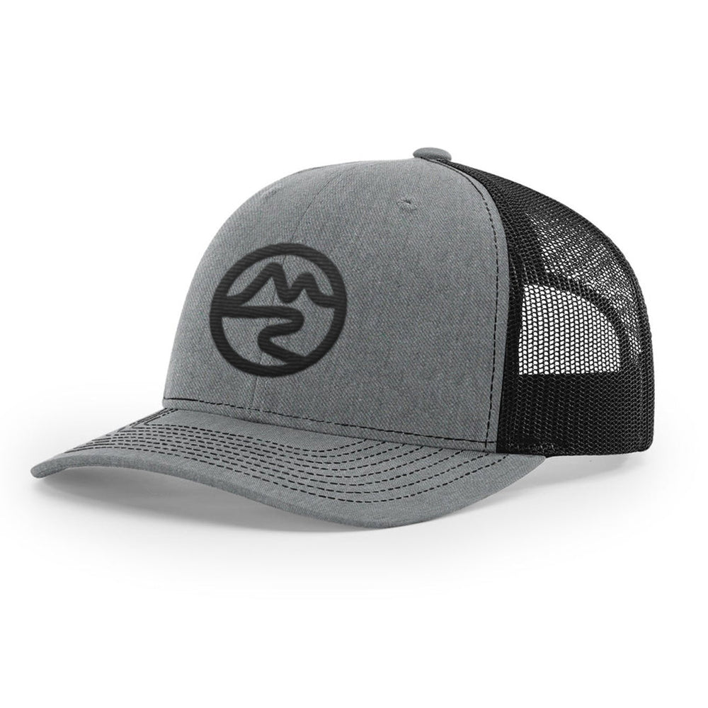 Side angle of Mtn Flo gray and black trucker cap with black Mtn Flo logo embroidered